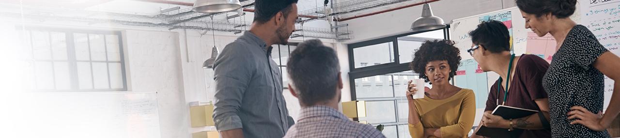 A tablet and open laptop sitting side-by-side on a table with the nationalbntexas.com online banking website on both screens
