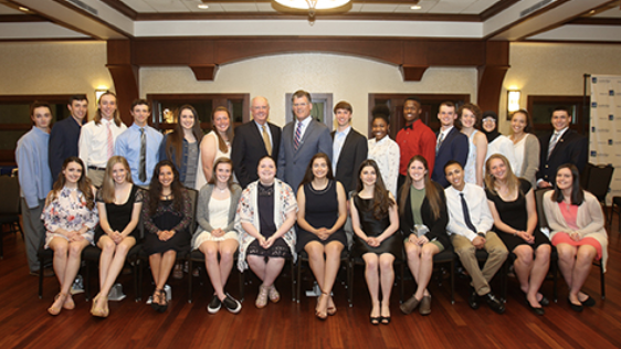 A group of scholarship recipients and NBT employees posing for the camera at an event